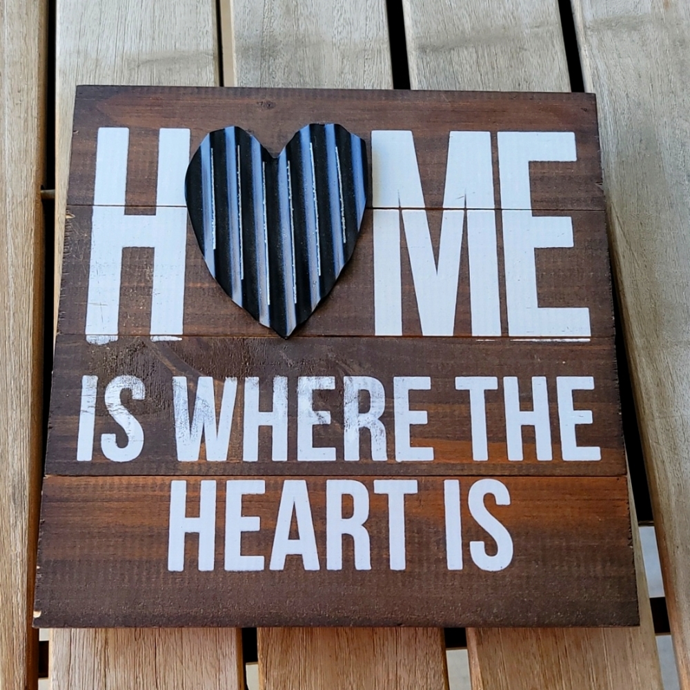 A wood wall art with 3D metal heart